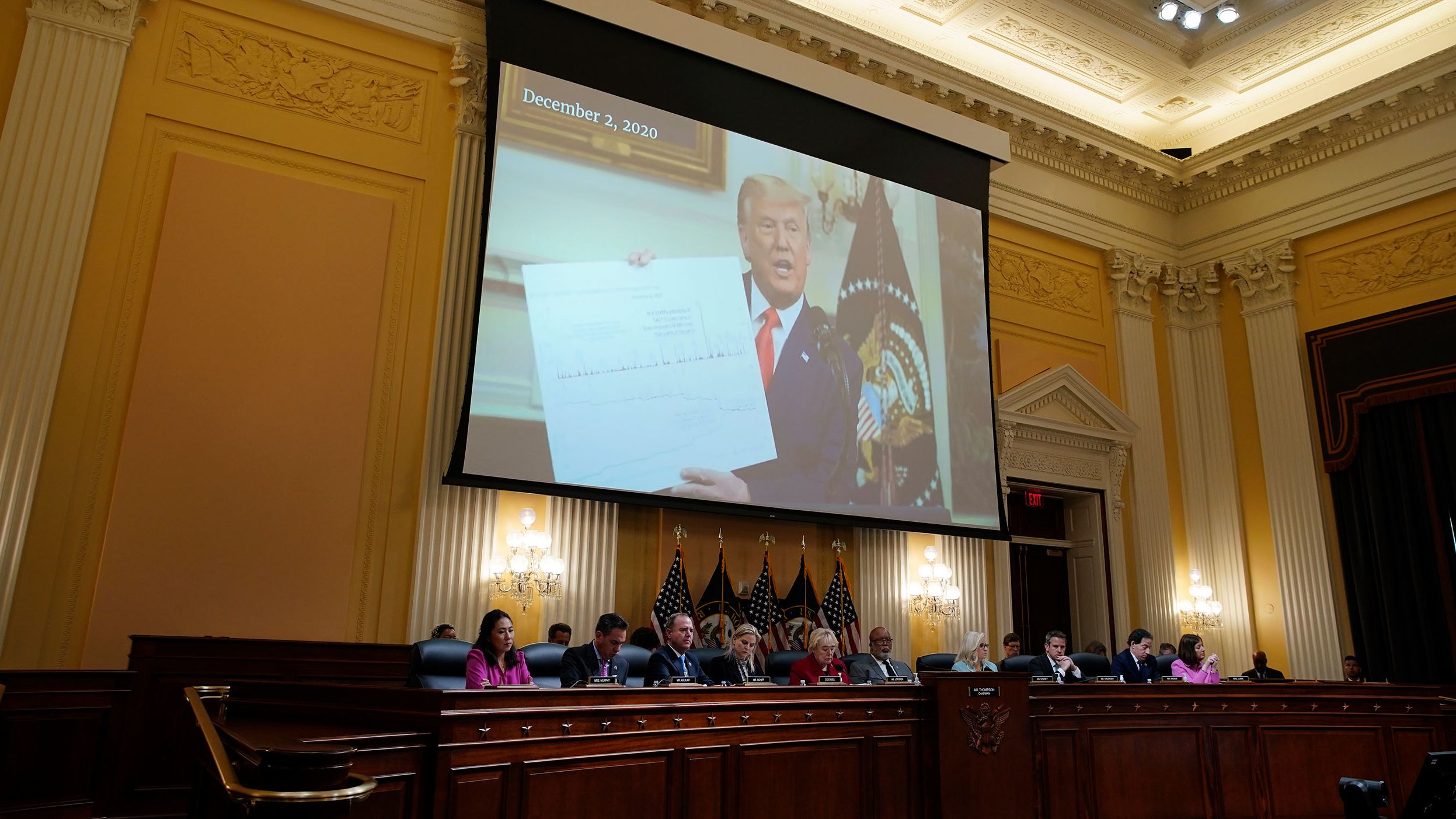 A video of Trump is displayed over the committee during the June 13 hearing.