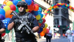 A heavily armed police officer walks along the street near the parade route of the New York City Pride Parade Sunday, June 26, 2016, in New York City, a year after New York City's storied gay pride parade celebrated a high point with the legalization of gay marriage nationwide. 