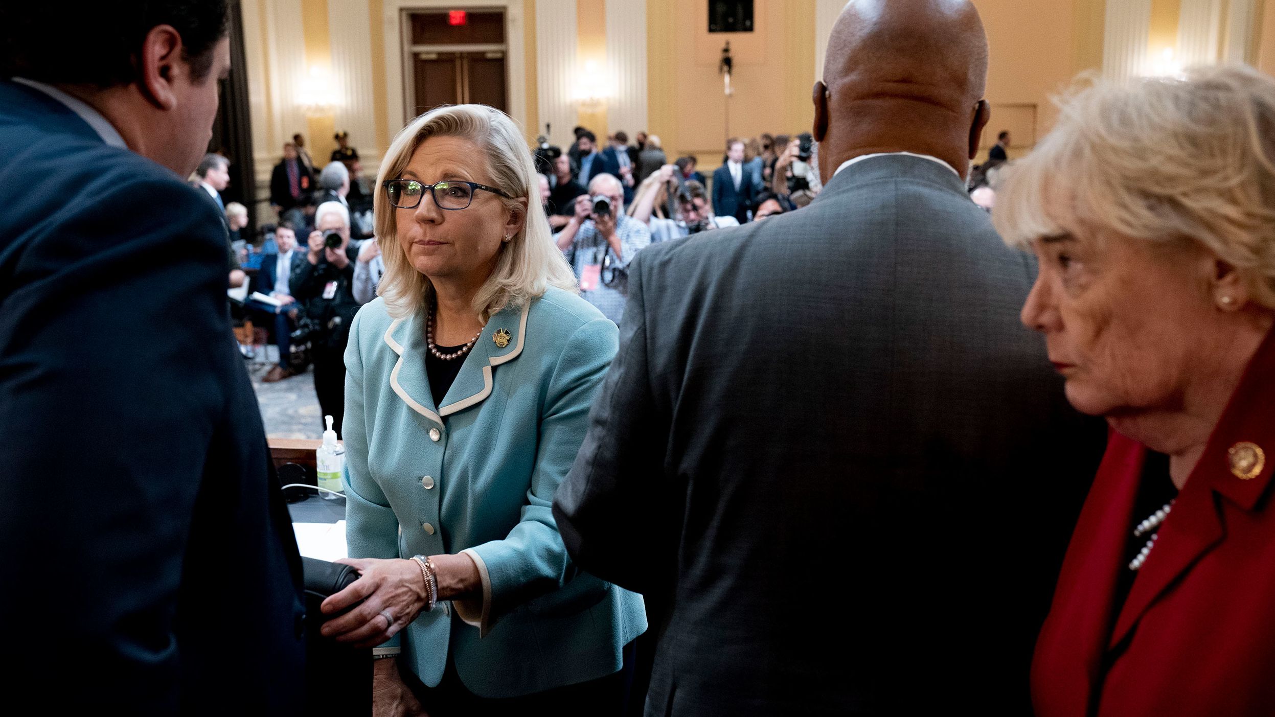 Members of the committee stand during a short recess on June 13.