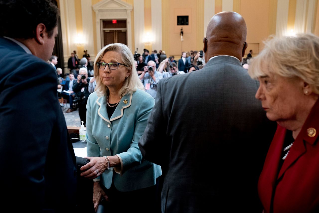 Members of the committee stand during a short recess on June 13.