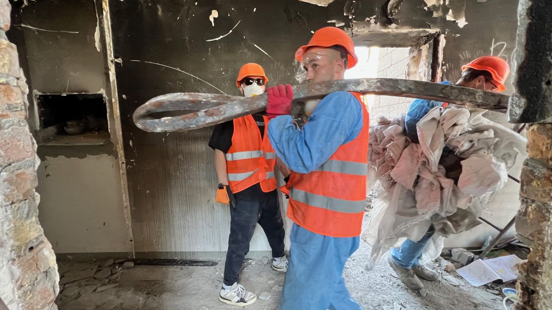 Volunteers clear rubble from an apartment building in the Kyiv suburb of Myla.