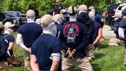 Police officers guard a group of men, who police say are among 31 arrested for conspiracy to riot and are affiliated with the white nationalist group Patriot Front, after they were found in the rear of a U Haul van in the vicinity of a North Idaho Pride Alliance LGBTQ+ event in Coeur d'Alene, Idaho on U.S. June 11, 2022.