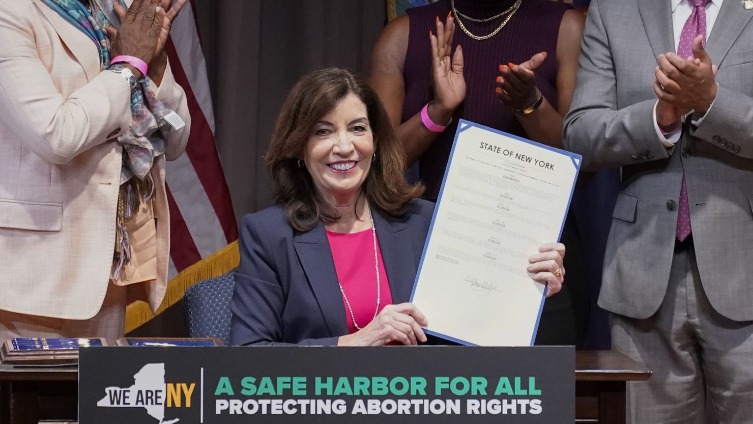 New York Gov. Kathy Hochul, center, poses for photos after signing a legislative package to protect abortion rights during a ceremony in New York on Monday, June 13, 2022.