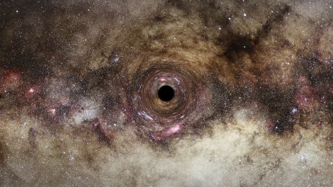This is the artistic impression of a black hole drifting through our galaxy, the Milky Way. 