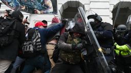 TOPSHOT - Riot police push back a crowd of supporters of US President Donald Trump after they stormed the Capitol building on January 6, 2021 in Washington, DC. - Donald Trump's supporters stormed a session of Congress held today, January 6, to certify Joe Biden's election win, triggering unprecedented chaos and violence at the heart of American democracy and accusations the president was attempting a coup. (Photo by ROBERTO SCHMIDT / AFP) (Photo by ROBERTO SCHMIDT/AFP via Getty Images)