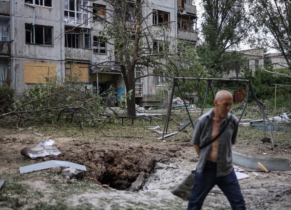 A local resident walks in front of an apartment building destroyed in a missile strike, amid Russia's invasion of Ukraine, in Bakhmut, Ukraine, June 13, 2022. 