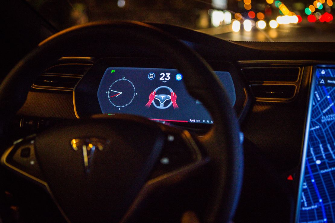 A Tesla dashboard is shown as the Autopilot software disengages during a drive in Brooklyn, New York.
