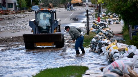 Residents of Red Lodge, Montana, clear mud, water and debris from the city's main street on Tuesday.