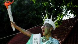 TOPSHOT - Cambodian-US human rights advocate Theary Seng, dressed as Lady Liberty, shouts slogans in front of the Phnom Penh municipal court on June 14, 2022. (Photo by TANG CHHIN Sothy / AFP) (Photo by TANG CHHIN SOTHY/AFP via Getty Images)