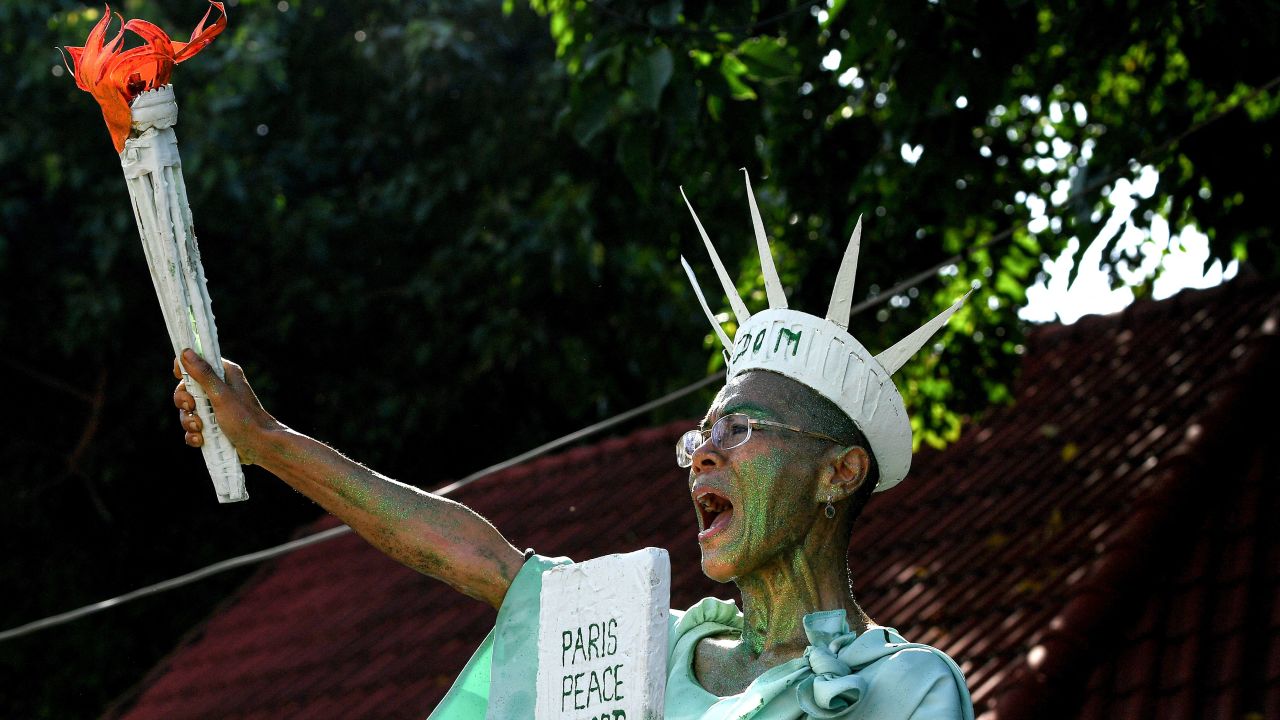 Cambodian-American lawyer Theary Seng, dressed as Lady Liberty, stands outside the Phnom Penh Municipal Court in Cambodia on Tuesday.