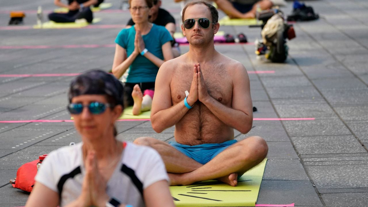 Yogis take part in the Solstice in Times Square event in 2021.
