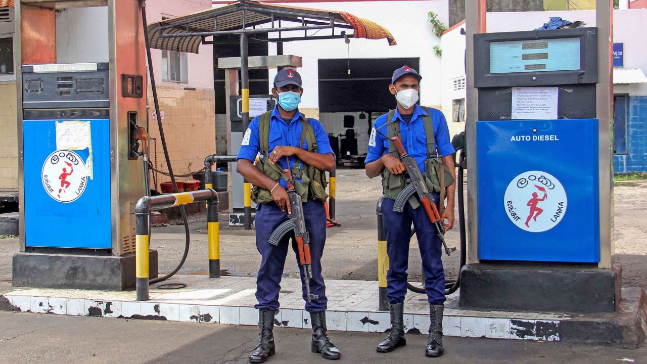 Naval officers  guard a closed fuel station in Colombo, Sri Lanka, on June 12.