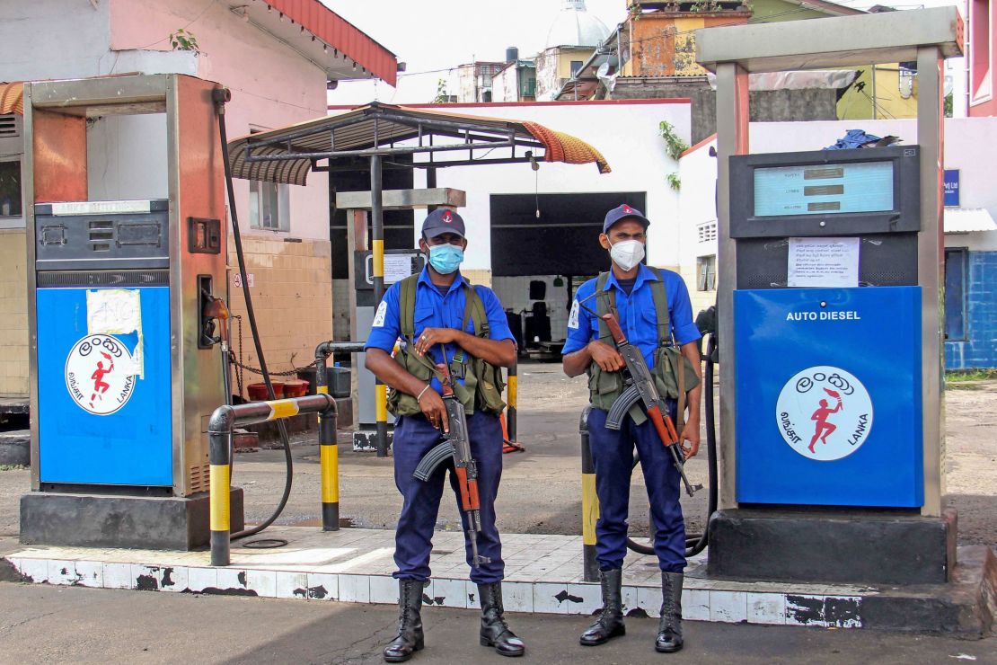 Naval officers  guard a closed fuel station in Colombo, Sri Lanka, on June 12.