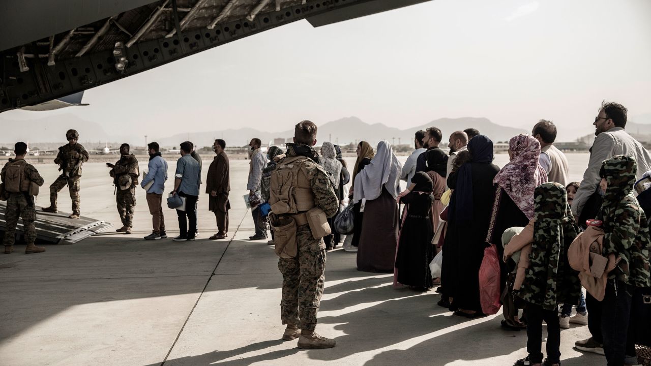 Evacuees wait to board a Boeing C-17 Globemaster III during an evacuation at Hamid Karzai International Airport in Kabul, Afghanistan, August 30, 2021. 