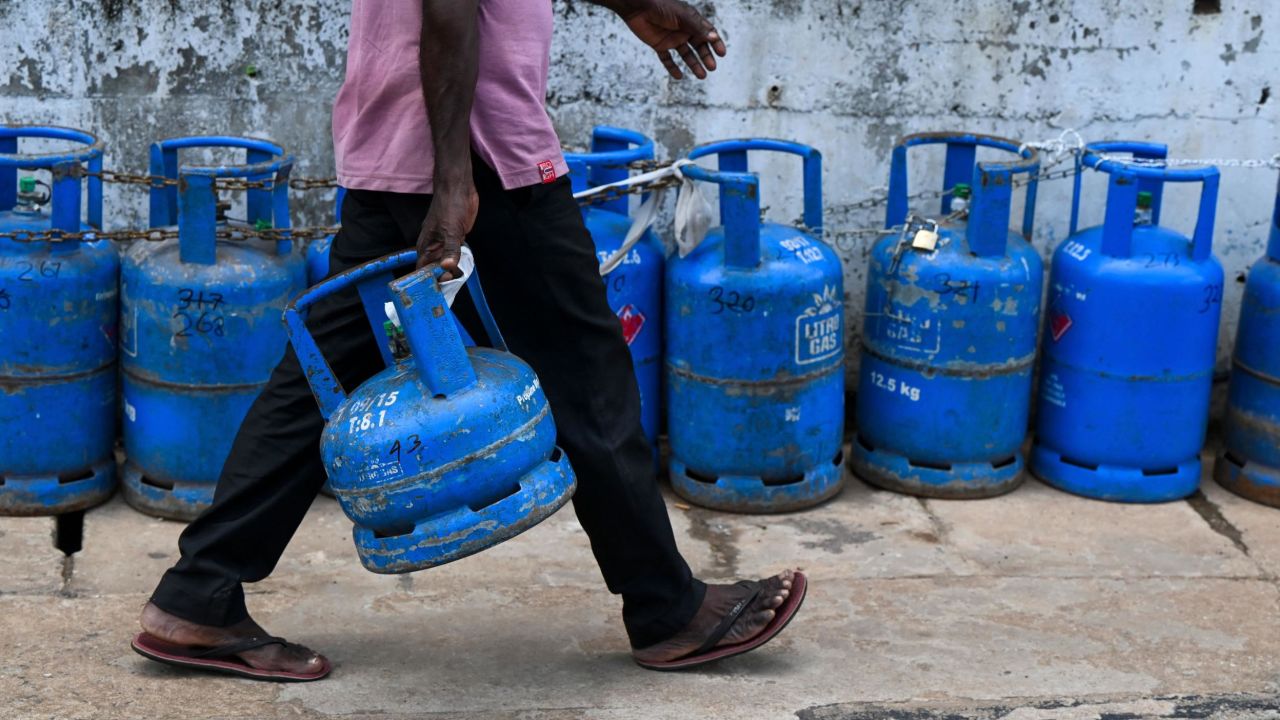 A man joins a queue to fill his gas cylinder in Colombo, Sri Lanka. 
