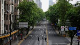 People stand on an empty street during lockdown, amid the coronavirus disease (COVID-19) pandemic, in Shanghai, China, May 26, 2022. 