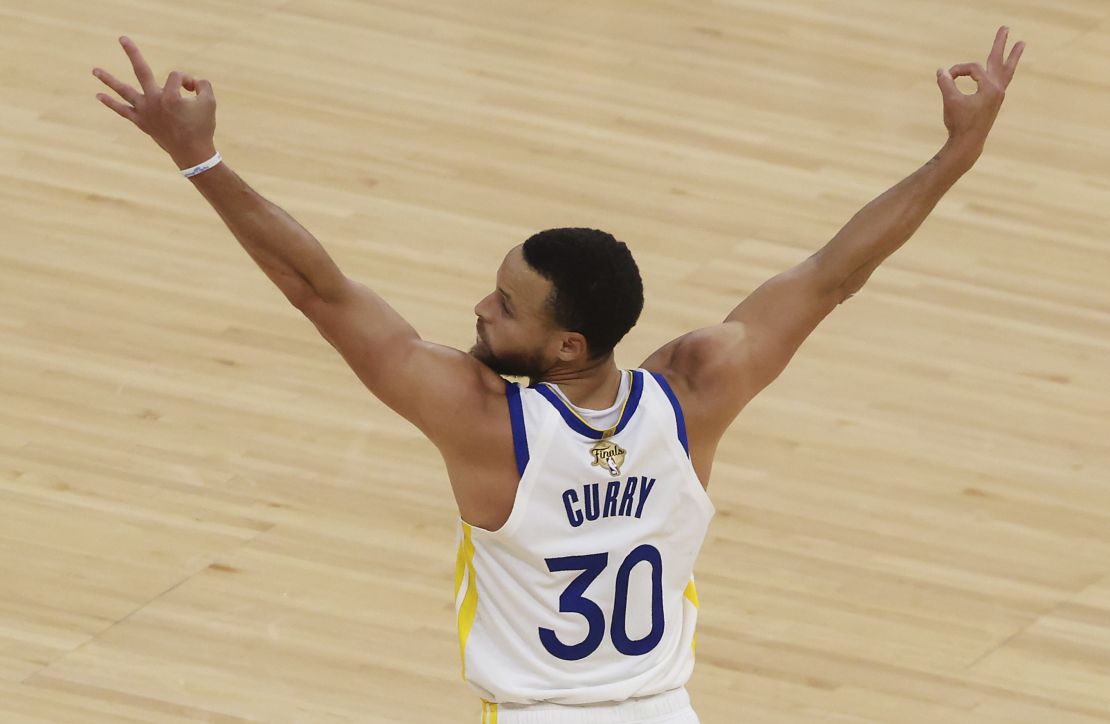 Curry reacts after teammate Klay Thompson makes a three-point basket against the Celtics.