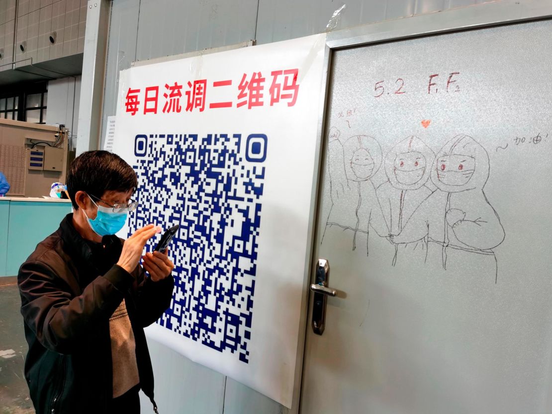 A patient scans the QR code in a temporary hospital for people infected with Covid-19 in Shanghai on April 24.