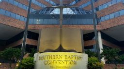 A cross and Bible sculpture stand outside the Southern Baptist Convention headquarters in Nashville, Tenn., on Tuesday, May 24, 2022. =