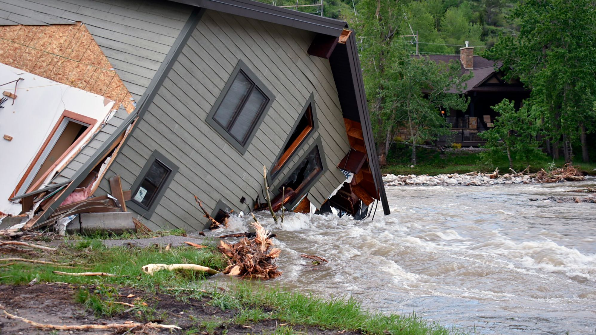 A house that was pulled into a flooded creek in Red Lodge, Montana, is pictured Tuesday.