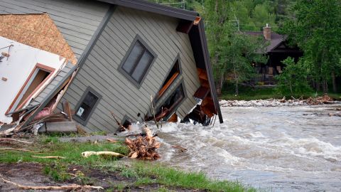 A house drawn into a flooded stream at Red Lodge, Montana is depicted on Tuesday.