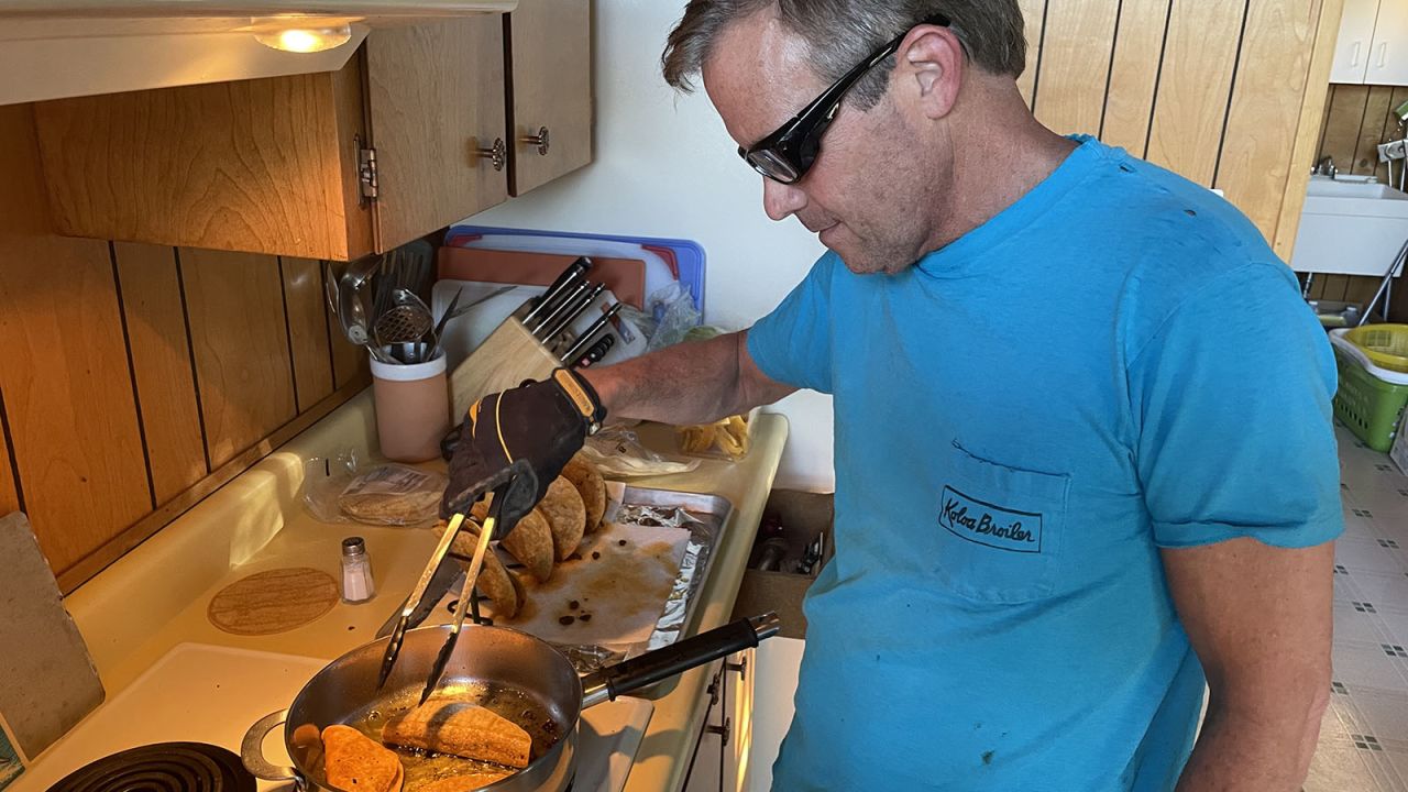 John "Wedge" Wardlaw fries tacos Tuesday night in his protective gear.