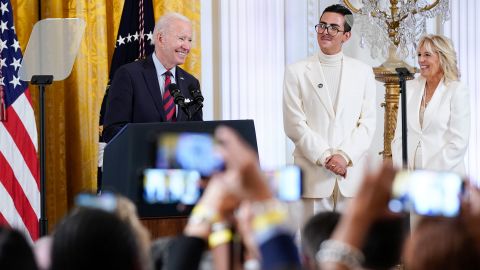 President Joe Biden speaks during an event to celebrate Pride Month in the East Room of the White House, Wednesday, June 15, 2022, in Washington. First lady Jill Biden, right, and youth activist Javier Gomez listen. 