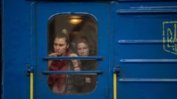 Passengers watch from the window of a train at Lviv-Holovnyi railway station as displaced Ukrainians flee to Poland, in Lviv, Ukraine, on Sunday, Feb. 27, 2022. 