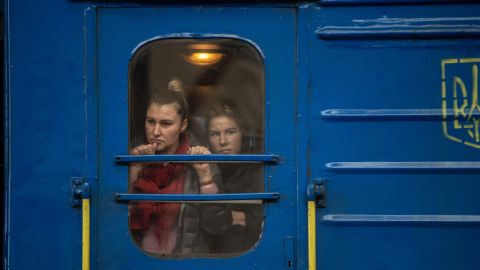Passengers watch from a train at Lviv-Holovnyi rail station as displaced Ukrainians flee to Poland in February. 