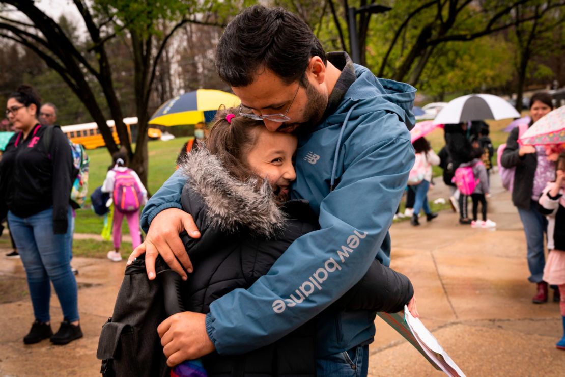 Arafat Safi, whose family fled Afghanistan, picks up his children from school in Alexandria, Virginia, April 7, 2022. 