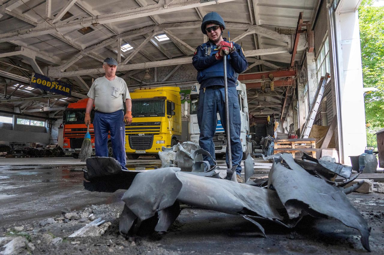 A Ukrainian bomb disposal expert looks at an ordnance shell during a mine clearance operation in Solonytsivka, near Kharkiv, Ukraine, on June 15.