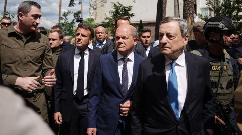 Oleksiy Chernyshov, Ukrainian President Zelensky's special envoy for EU accession, walks with French President Emmanuel Macron, German Chancellor Olaf Scholz and Italian PM Mario Draghi past destroyed buildings in Irpin, Ukraine, on June 16.