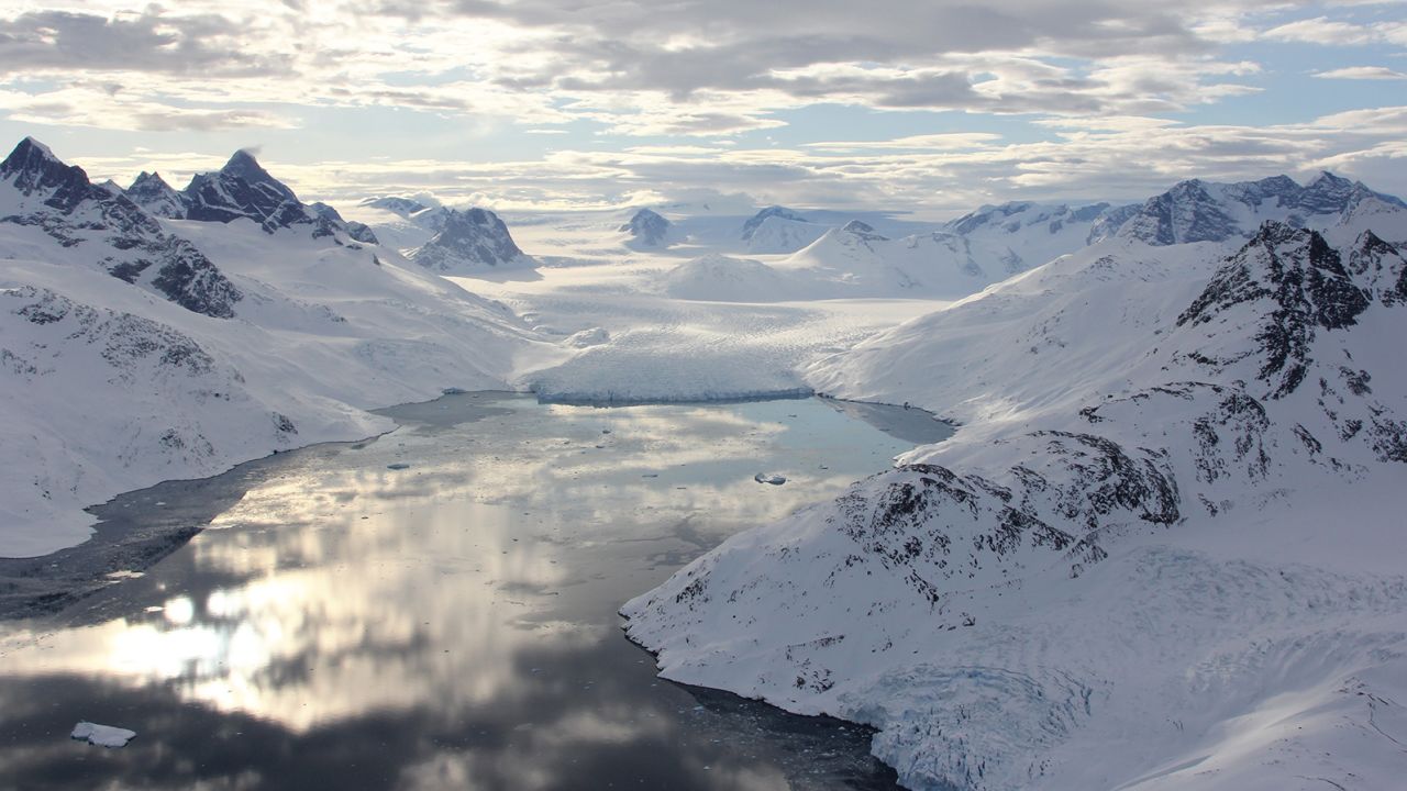 A fjord in southeast Greenland is shown filled with open water in April 2016.