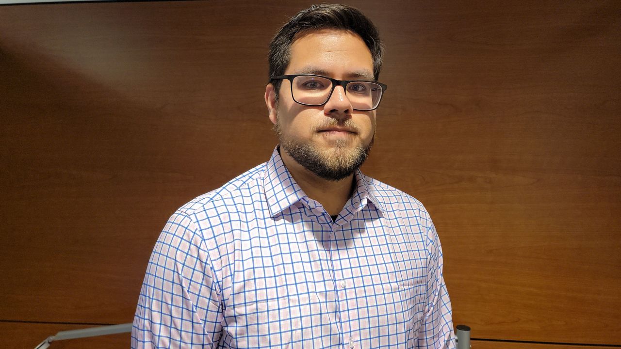 Angel Enriquez went to college hoping to move up the economic ladder. 