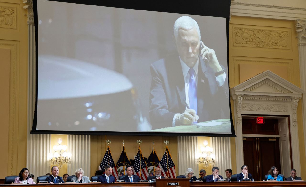 A photo of then-Vice President Mike Pence is displayed over the committee during a hearing on June 16. In the photo, Pence is speaking on the phone from a secure location during the January 6 riot. <a href=