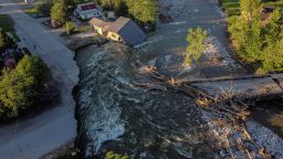 A house sits in Rock Creek after floodwaters washed away a road and a bridge in Red Lodge, Mont., Wednesday, June 15, 2022. (AP Photo/David Goldman)