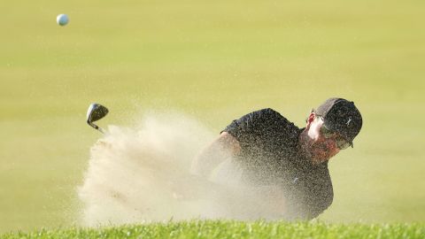 Mickelson plays a shot from a bunker on the 15th hole.