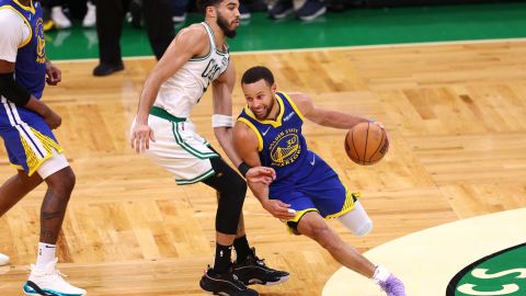MVP Stephen Curry passes the Celtics' Jayson Tatum in the deciding Game 6 in Boston.