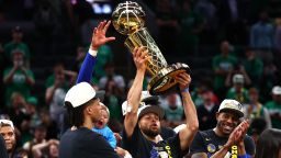 Stephen Curry #30 of the Golden State Warriors raises the Larry O'Brien Championship Trophy after defeating the Boston Celtics 103-90 in Game Six of the 2022 NBA Finals at TD Garden on June 16, 2022 in Boston, Massachusetts. 