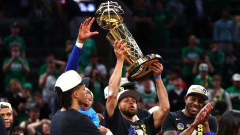 BOSTON, MASSACHUSETTS - JUNE 16: Stephen Curry #30 of the Golden State Warriors raises the Larry O'Brien Championship Trophy after defeating the Boston Celtics 103-90 in Game Six of the 2022 NBA Finals at TD Garden on June 16, 2022 in Boston, Massachusetts. (Photo by Elsa/Getty Images)