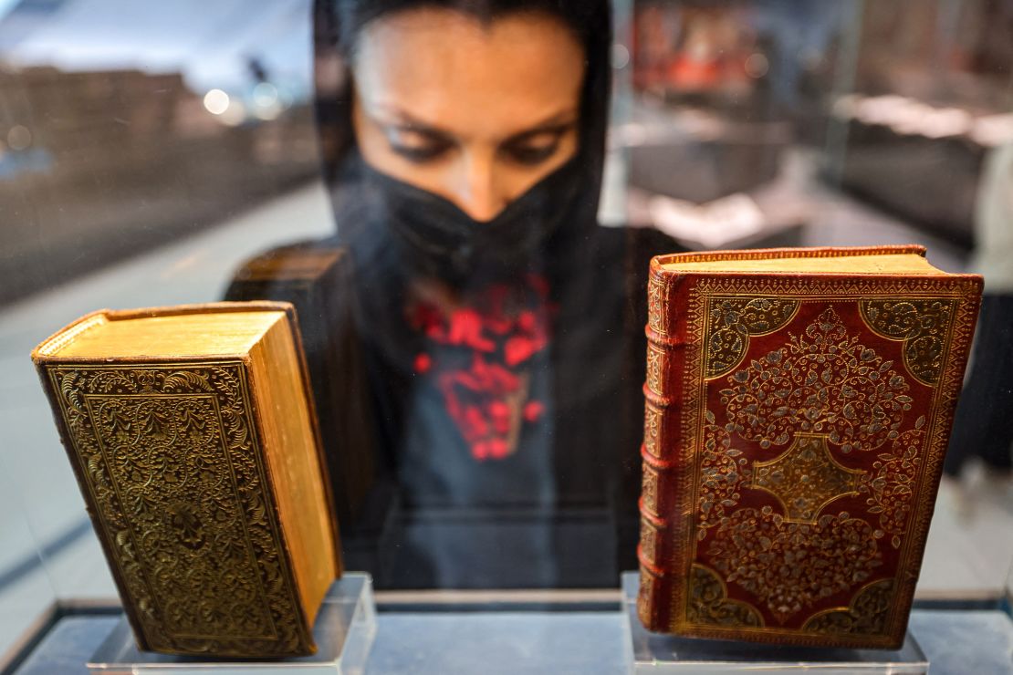 A visitor views a 1644 manuscript copy of the "Sacred Prayers of the Christian Soul" by Pierre Moreau (R) on display at the newly-opened Mohammed Bin Rashid library (MBRL) in Dubai on June 16.