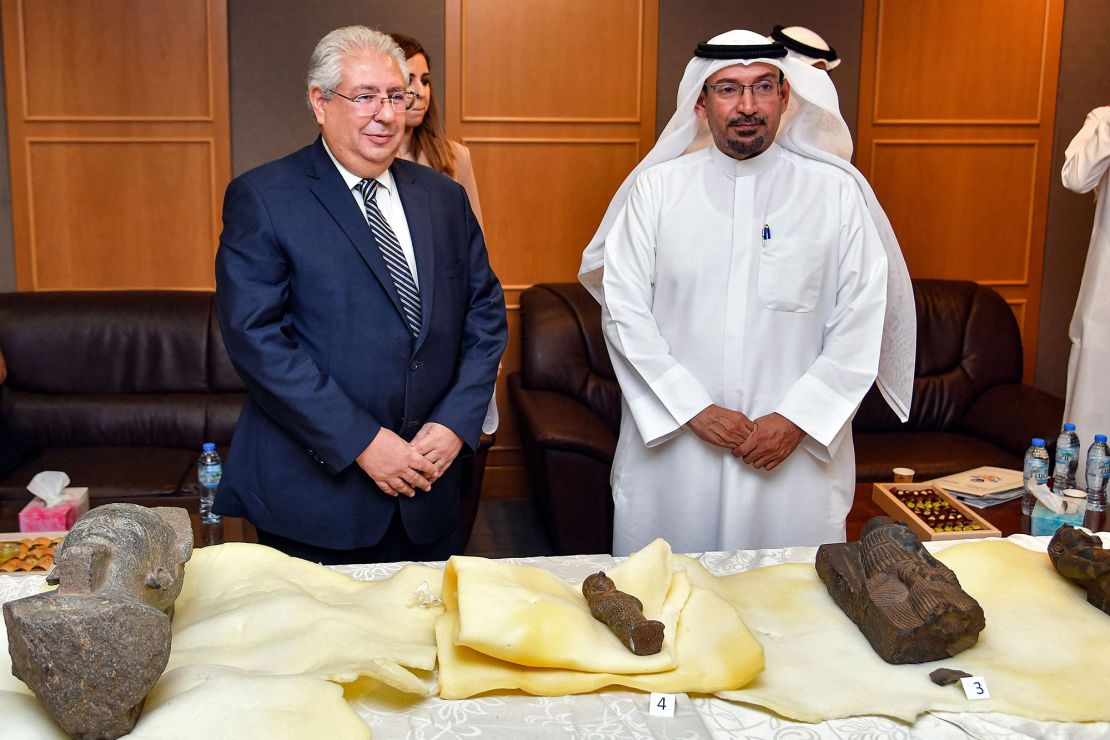 Sultan al-Mutlaq al-Dawis (R), of Kuwait's National Council for Culture, Arts, and Literature, stands alongside Egypt's ambassador to Kuwait Osama Shaltout (L) during a handover ceremony for five artifacts at the Egyptian embassy in Kuwait City on June 16. 