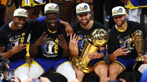 Andre Iguodala, Draymond Green, Klay Thompson and Curry pose for a photo after defeating the Boston Celtics in Game 6 of the 2022 NBA Finals.