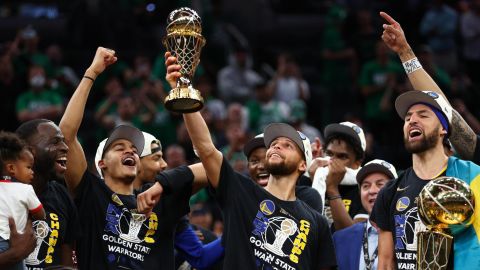Curry raises the Bill Russell NBA Finals MVP Award after defeating the Celtics in Game 6 of the 2022 NBA Finals.