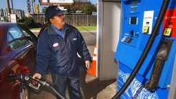 Station attendant, George Samaniego, pumps gas at an Exxon gas station in Jersey City, New Jersey, Thursday, October 28, 2004. 
