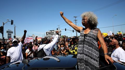 Civil rights icon Angela Davis pumps her fist in solidarity during a Juneteenth protest against police brutality  in Oakland, California, in 2020.