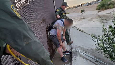 US Border Patrol agents in the El Paso sector this week rescued a migrant trying to cross the canal, where a fast-moving current poses a grave risk. Customs and Border Protection has blurred a portion of this image. 