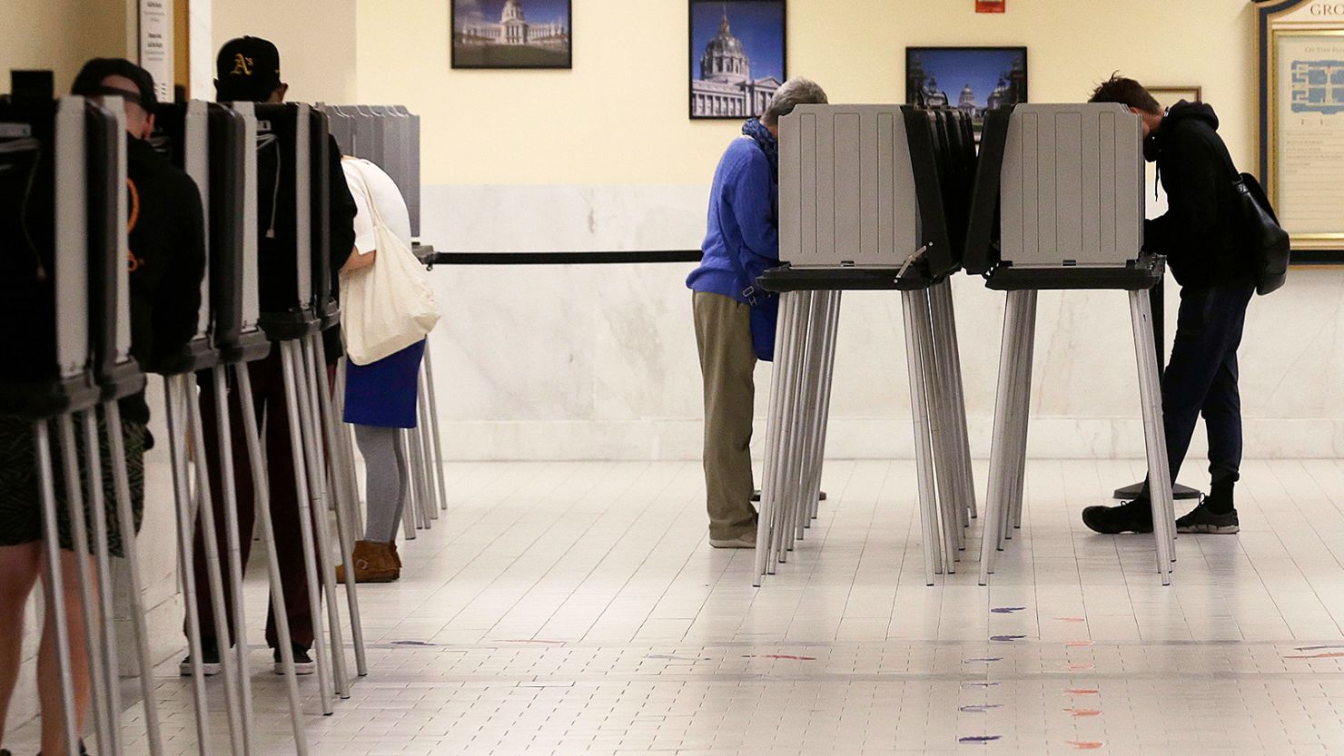 Voters cast ballots in voting booths at City Hall in San Francisco on June 7, 2016.