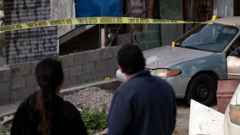 Margarito Martinez's wife, Maria Elena Frausto Granados (L), stands at the site where her husband was shot dead in January.