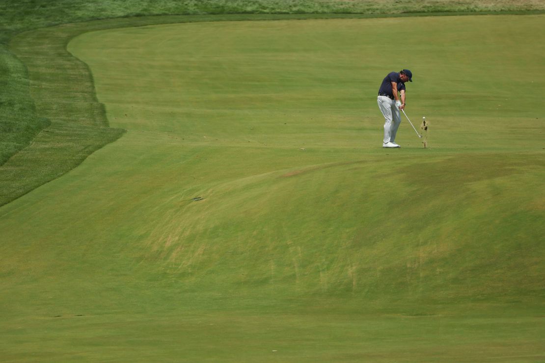 Mickelson plays an approach shot on the ninth hole.